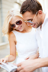 Image showing couple with tourist book in the city