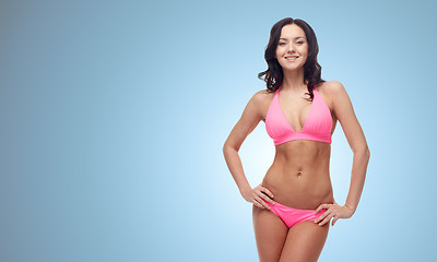 Image showing happy young woman in pink bikini swimsuit