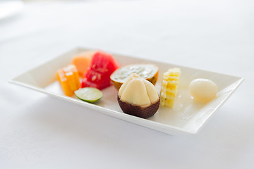 Image showing plate of fresh juicy fruit dessert at restaurant