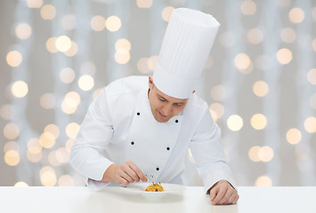 Image showing happy male chef cook decorating dish