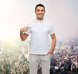 Image showing smiling man in t-shirt pointing finger on himself