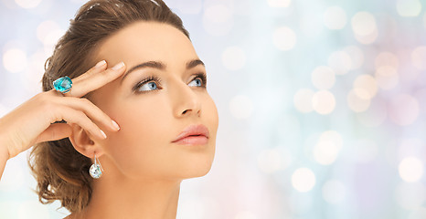 Image showing close up of woman face with ring and earrings