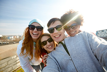 Image showing group of happy friends taking selfie on street