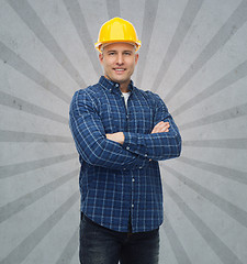 Image showing smiling male builder or manual worker in helmet