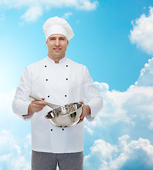 Image showing happy male chef cook whipping something with whisk