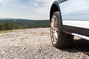 Image showing close up of dirty car wheel on cliff