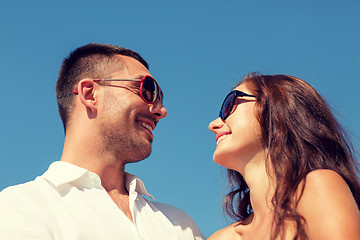 Image showing smiling couple over blue sky background