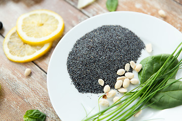 Image showing close up of peeled peanuts, greens and chia seeds