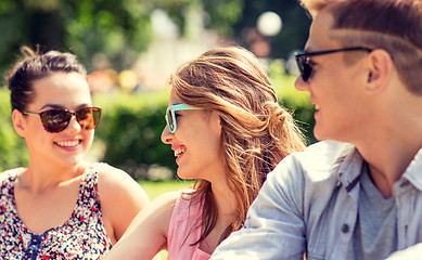 Image showing group of smiling friends outdoors sitting in park