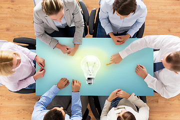 Image showing close up of business team sitting at table