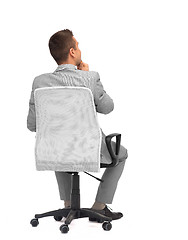 Image showing businessman sitting in office chair from back