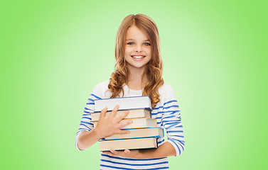 Image showing happy little student girl with many books