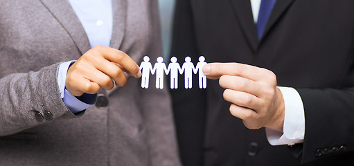 Image showing businessman and businesswoman holding paper team