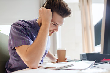 Image showing creative male office worker with coffee thinking