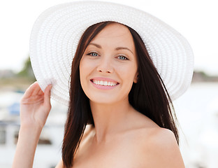 Image showing girl in hat standing on the beach