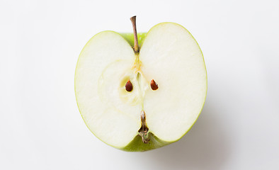 Image showing ripe green apple half over white
