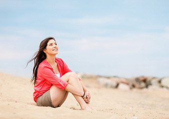 Image showing girl sitting on the beach