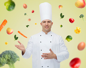 Image showing happy male chef cook inviting