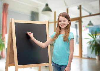 Image showing happy little girl with blackboard and chalk