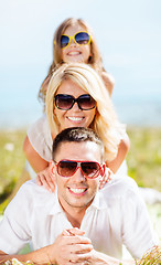 Image showing happy family with blue sky and green grass