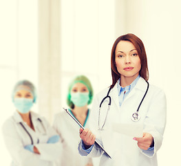 Image showing calm female doctor with clipboard