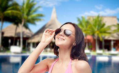 Image showing happy woman in sunglasses and swimsuit on beach