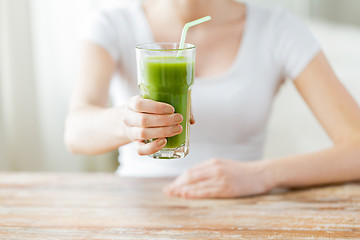 Image showing close up of woman hands with green juice
