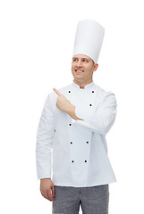 Image showing happy male chef cook pointing finger up