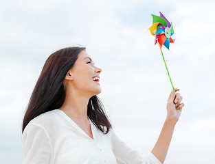 Image showing girl with windmill toy on the beach