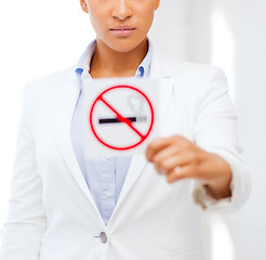 Image showing african woman with restriction no smoking sign