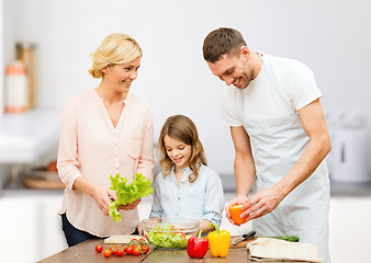 Image showing happy family cooking vegetable salad for dinner