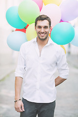 Image showing man with colorful balloons in the city