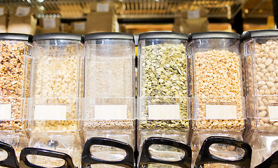 Image showing row of jars with nuts and seeds at grocery store