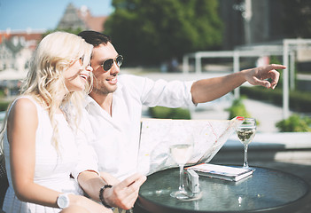 Image showing couple with map in cafe