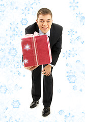 Image showing businessman with pink gift package and snowflakes