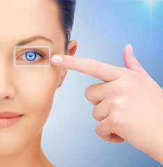 Image showing beautiful woman pointing to eye