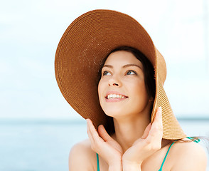 Image showing girl in hat standing on the beach