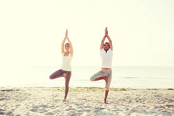 Image showing couple making yoga exercises outdoors