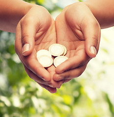 Image showing womans cupped hands showing euro coins