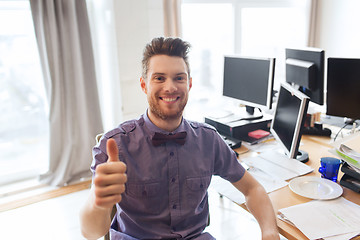 Image showing happy male office worker showing thumbs up