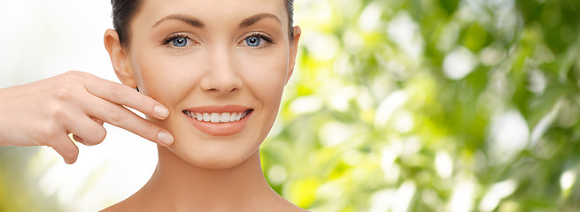 Image showing face and hand of smiling woman over green tarure