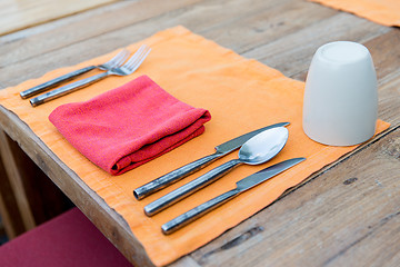 Image showing close up of cutlery with glass and napkin on table