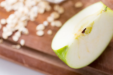 Image showing close up of green apple on wooden cutting board