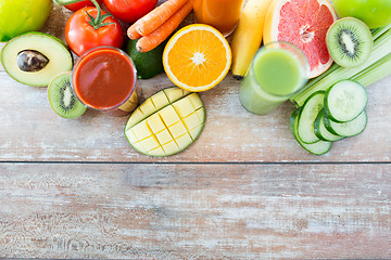 Image showing close up of fresh juice glass and fruits on table