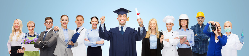 Image showing happy bachelor with diploma over professionals