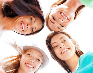 Image showing faces of girls looking down and smiling