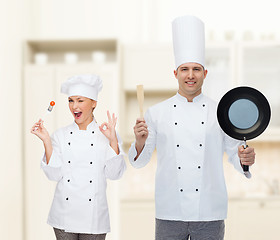 Image showing happy male chef holding frying pan and spatula