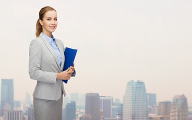 Image showing smiling businesswoman holding folder