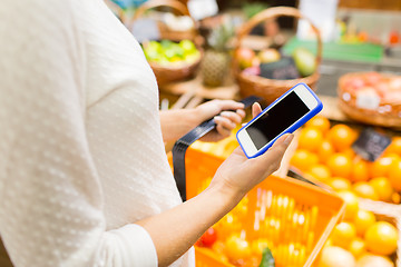 Image showing close up of woman with food basket in market