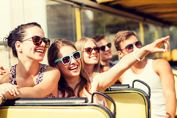 Image showing group of smiling friends traveling by tour bus